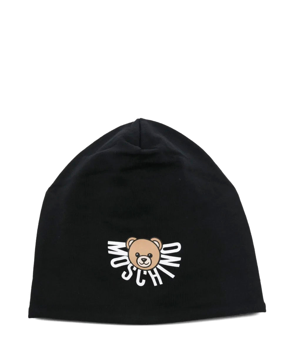 Cappello nero Moschino Kids in jersey con logo e orsetto Teddy stampato. Un accessorio comodo e stiloso per look casual e urban dei più piccoli.
