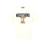 T-shirt panna Moschino Kids in cotone con stampa orsetto Teddy e logo. Comfort e stile per un look casual e riconoscibile ogni giorno.