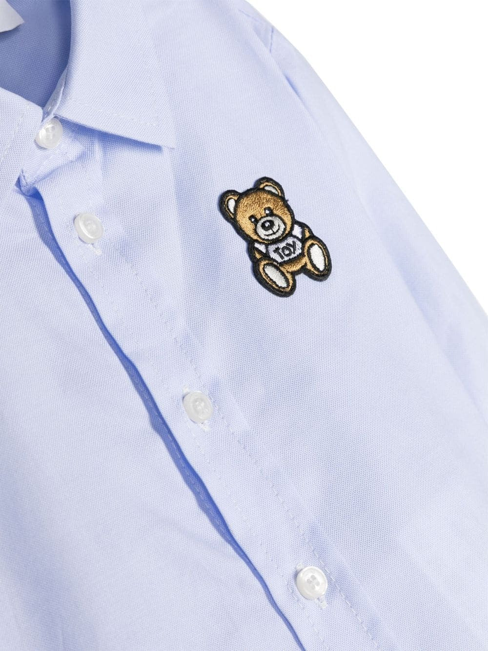 Camicia Moschino Kids Celeste con Teddy Bear: Eleganza e Giocosità per il Tuo Piccolo